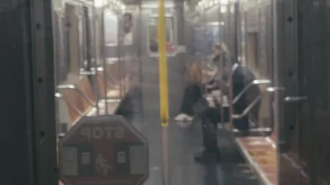 Interior of a NYC subway car in motion, with orange and yellow seats Stock Footage 309707017