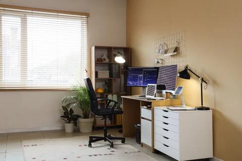 Interior of office with programmer's desk, lamp and shelf unit Stock-Fotos