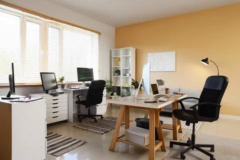 Interior of office with programmer's desks, shelf unit and sofa Stock-Fotos