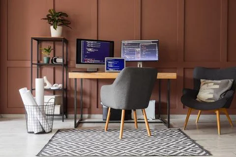 Interior of office with programmer's workplace, shelf unit and armchair Stock-Fotos