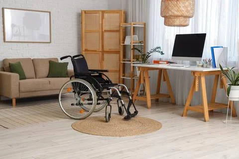 Interior of office with sofa, workplace and wheelchair Stock Photos