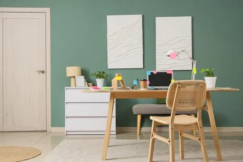 Interior of office with workplace, sticky notes and paintings Stock Photos