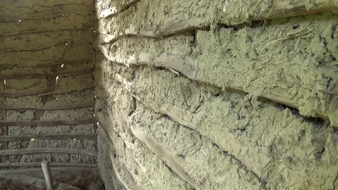 The interior of the old and abandoned hut. wall of mud and straw Stock Footage 113193151
