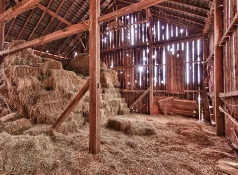 Interior of old barn with straw bales Stock Photos