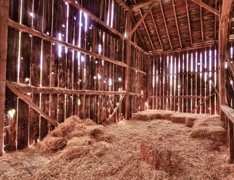 Interior of old barn with straw bales Stock Photos
