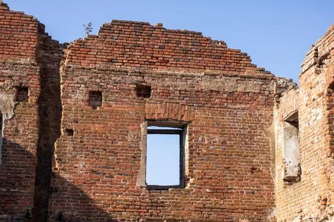 Interior of an old brick building, trees visible outside Stock Photos