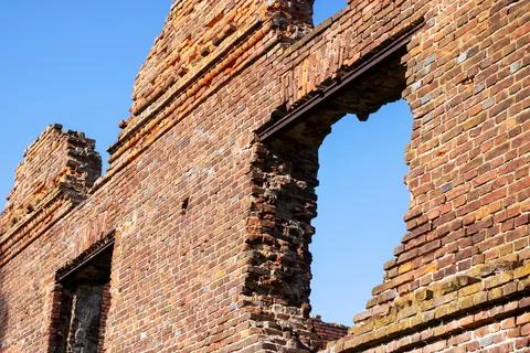 Interior of an old brick building, trees visible outside Fotos de archivo