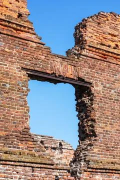 Interior of an old brick building, trees visible outside Fotos de archivo