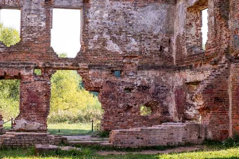 Interior of an old brick building, trees visible outside Fotos de archivo