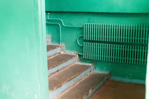 Interior of an old building in poor condition with green painted walls, crack Stock Photos