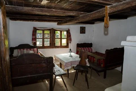 Interior of an old house with two beds, a table, a OLD VINTAGE kerosene lam.. Stock Photos