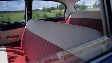 Interior of an old Soviet car front and rear seats, handmade, sunny summer day Stock Footage 129305940