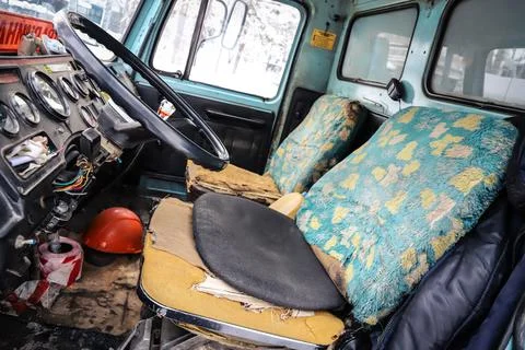 Interior of an old truck with a broken seat Stock Photos