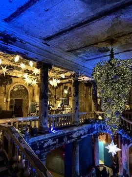 Interior of an old, worn-down church, upside-down Christmas tree 스톡 사진