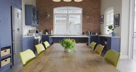 Interior of open plan kitchen and dining room with table and chairs Stock Footage 344332840