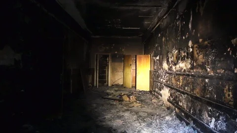 The interior or dark corridor of the burnt down building after the fire Stock Footage 89360575