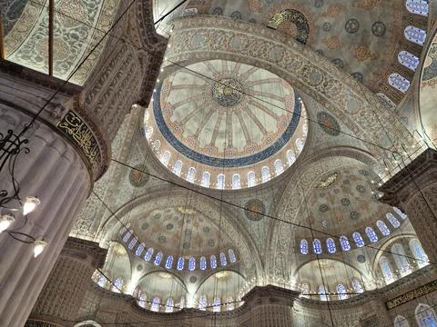 Interior of ornate mosque domed ceiling with Arabic calligraphy Stock Photos