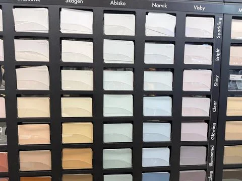 Interior paint samples displayed inside home improvement store. 스톡 사진