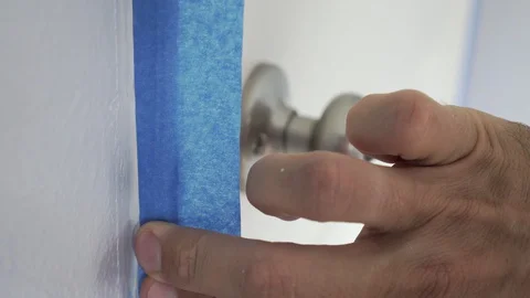 Interior Painter Using Masking Tape to Secure Wooden Window Frame. Stock Footage 129137512
