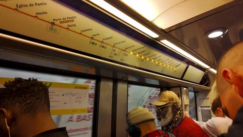 Interior of Paris Metro line 5 train showing route map and passengers during Stock Footage 311873569