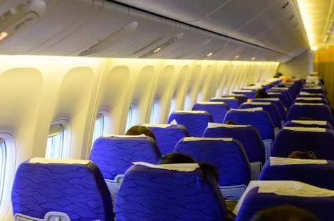 Interior of a passanger plane during flight Stock Photos