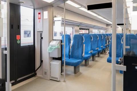 Interior of the passenger train with empty blue fabric seats Stock Photos