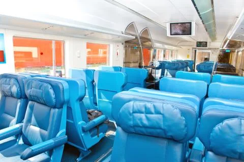 Interior of a passenger train with empty seats.. Stock Photos