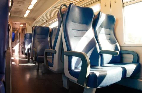 Interior of a passenger train with empty seats. Stock Photos