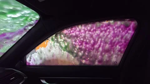 The interior perspective of a car wash. The car wash is operated by a machine. A Stock Footage 304286079