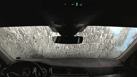 Interior perspective of a vehicle being washed at night, showcasing the Stock Footage 333798256