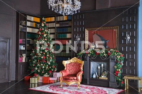 Interior photo studio with Christmas decor. Fireplace, Christmas tree, gifts of Stock Photos