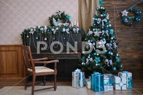 Interior photo studio with Christmas decor. Piano, Christmas tree, gifts on a Stock Photos