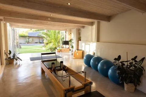 Interior of pilates studio with exercise equipment and plants Photos