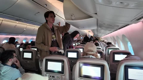 The interior of a plane with passengers disembarking Stock Footage 340165922