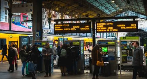 Interior of Porto train station where people walk on the dock Stock Photos