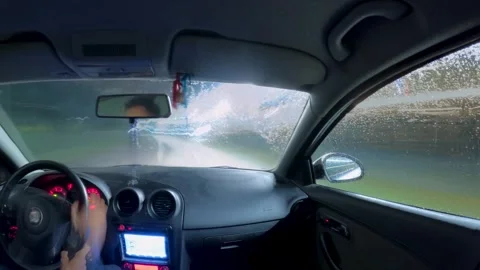 Interior POV of a Car Being Washed in an Automatic Machine at Night Water Stock Footage 325713178