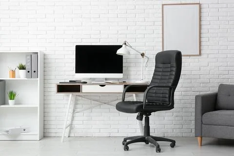 Interior of programmers office with workplace and shelf unit 스톡 사진