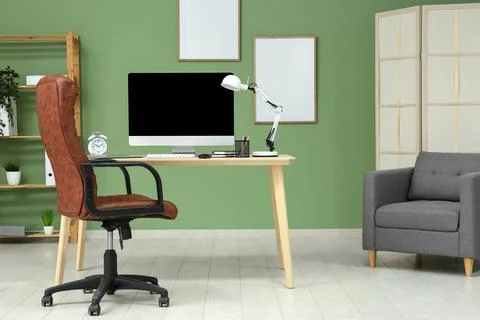 Interior of programmers office with workplace, armchair and shelf unit 스톡 사진