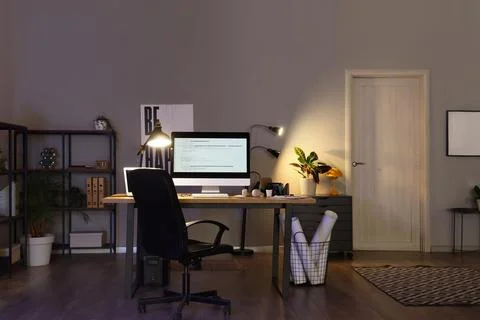 Interior of programmer's office with workplace, shelf unit and glowing lamps Stock-Fotos