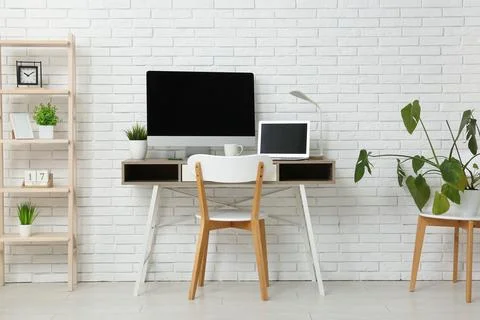 Interior of programmer's office with workplace, shelf unit and plants Stock-Fotos