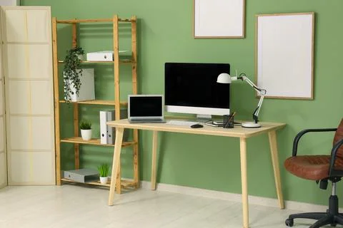 Interior of programmer's office with workplace, shelf unit and plants Stock-Fotos
