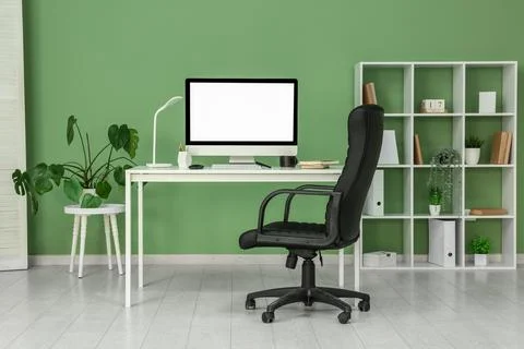 Interior of programmer's office with workplace, shelf unit and plants Stock-Fotos