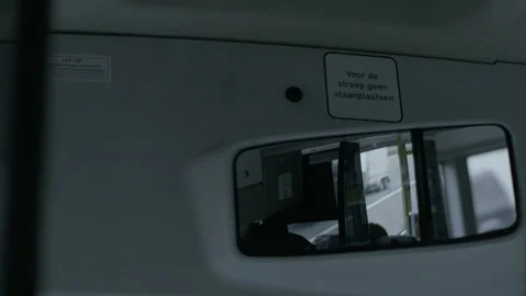 Interior Rearview Mirror and Dutch Safety Sign in Bus Stock Footage 343978773