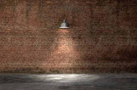 An interior with a red brick wall and concrete floor Foto stock