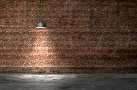 An interior with a red brick wall and concrete floor Foto stock