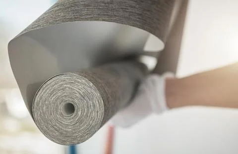 Interior Remodeling Worker with Roll of Modern Vinyl Wallpaper Stock Photos