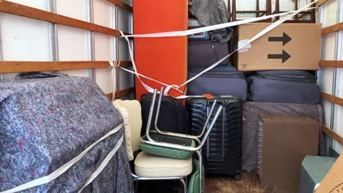 The interior of a removal van, filled with household items. Static shot 4K. Stock Footage 284346617