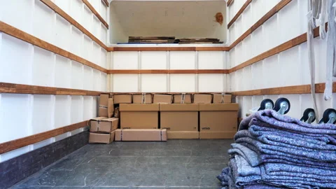 The interior of a removal van, showing stacked cardboard boxes, static shot. Stock Footage 267962076