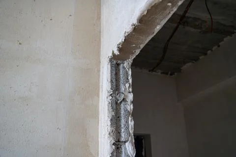 Interior renovation using white gypsonite plaster on concrete doorway. Stock Photos