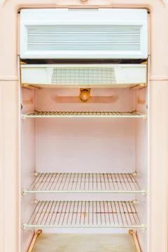 Interior of a retro pink fridge Stock Photos